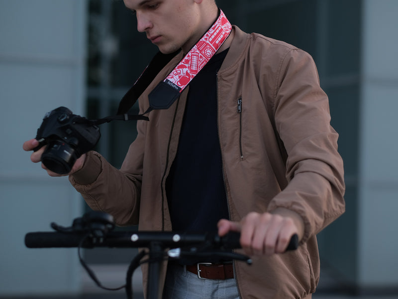 Personalized camera strap for tourists with London and UK symbols.